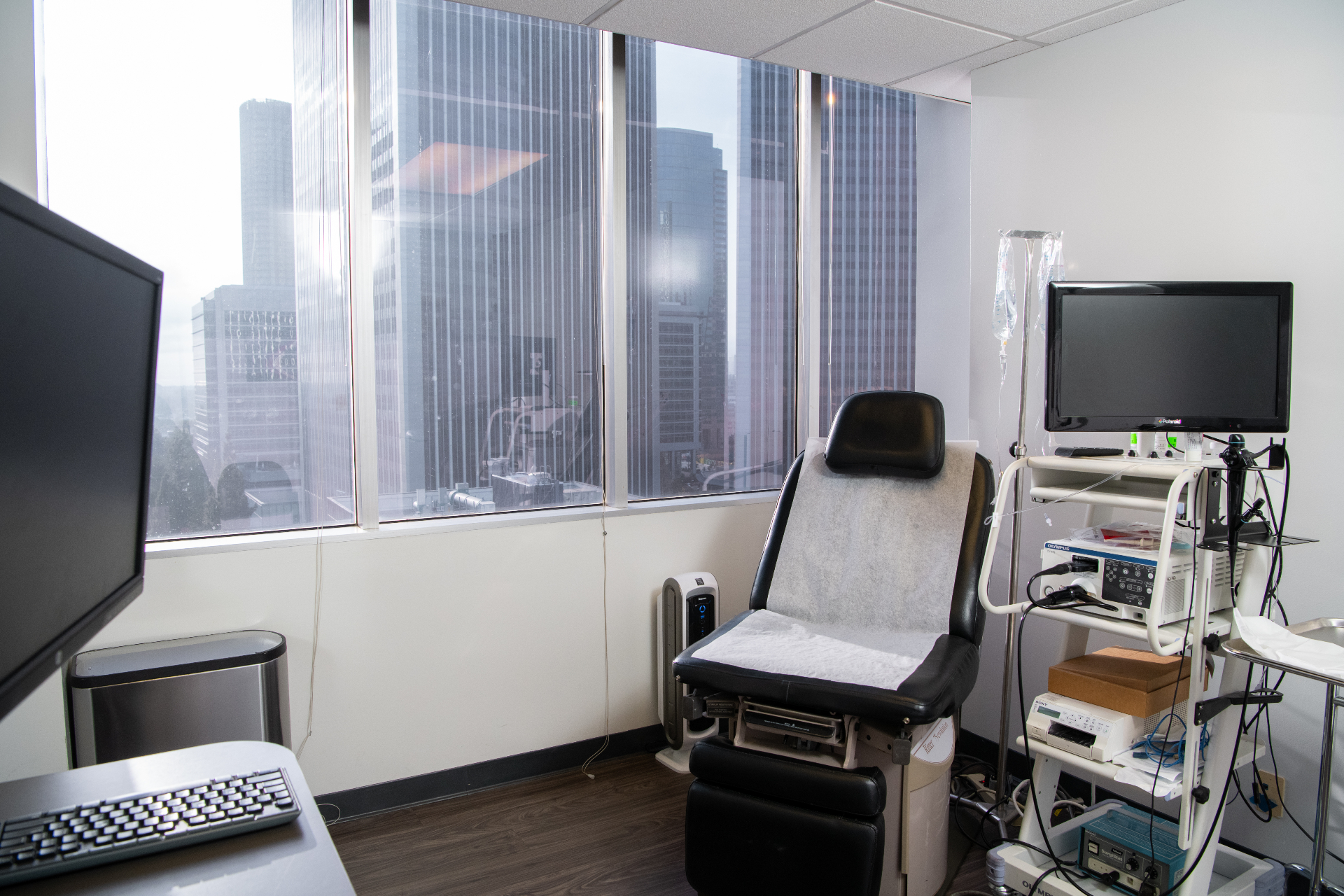 Beverly Hills Urology consultation room with floor-to-ceiling windows and procedure equipment